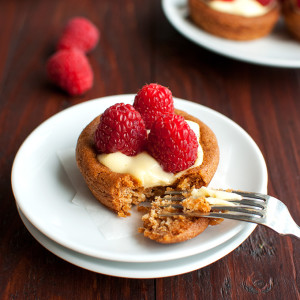 Raspberry Tartlets with Pastry Cream Filling - buttery, crumbly pastry filled with silky vanilla pastry cream and topped with fresh raspberries. Yum! | thetoughcookie.com