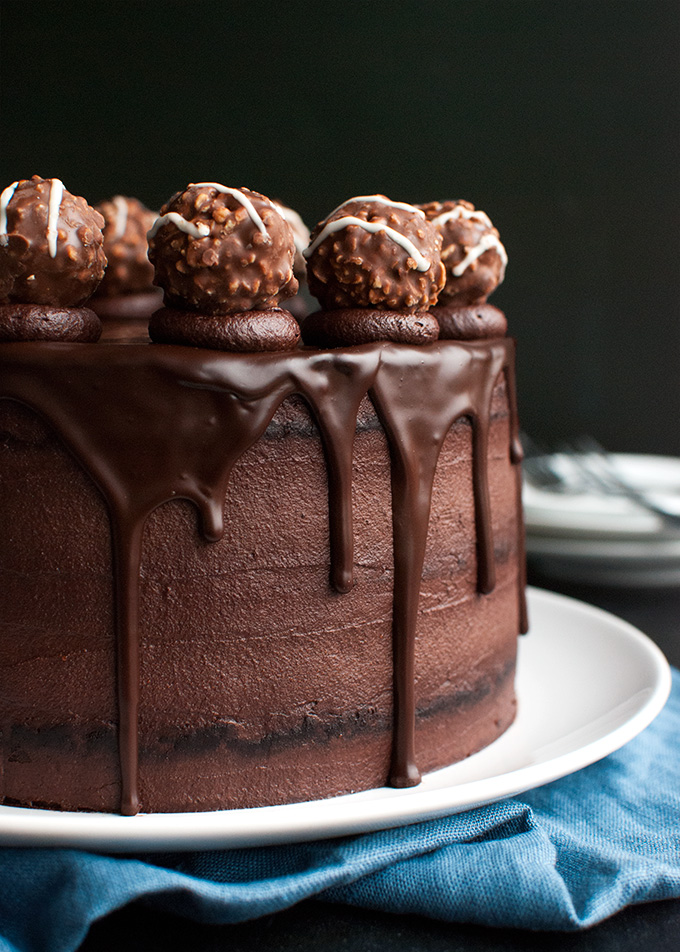 Triple Dark Chocolate Cake - chocolate cake, filled with the best dark chocolate buttercream and topped with chocolate ganache and truffles! | thetoughcookie.com