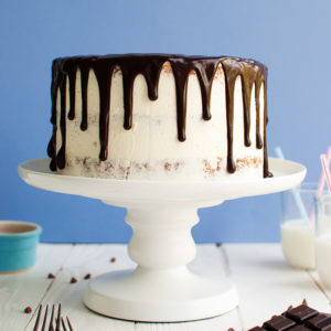 Vanilla Chocolate Chip Drip Cake - Light and fluffy vanilla chocolate chip cake layers filled with Swiss vanilla buttercream and decorated with a dark chocolate drip. Easy but delicious! | thetoughcookie.com